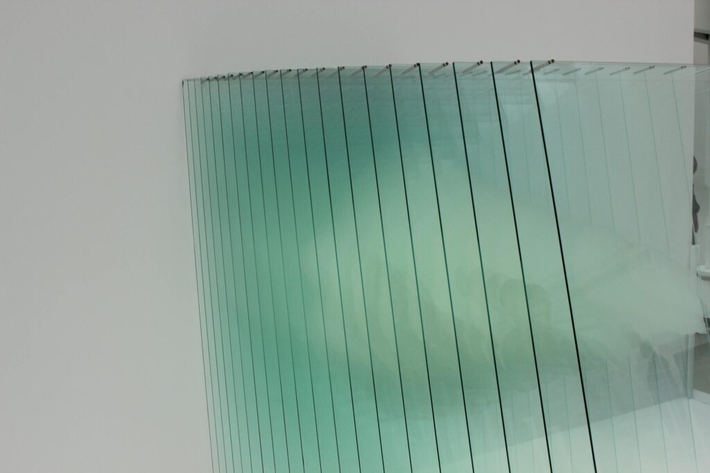 What's the Difference Between Annealed, Tempered, and Laminated Glass? 3 Abstract image showing glass panels